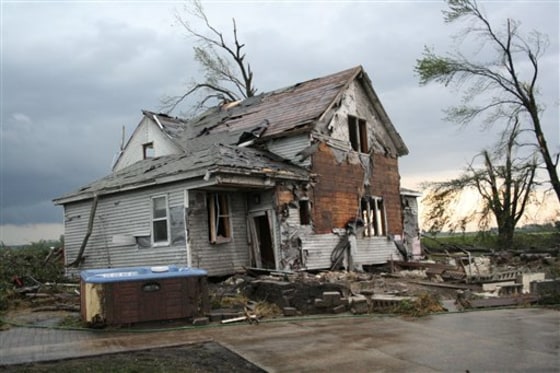 A home stands badly damaged after a tornado struck a farming area west of Armstrong, Minn., on Thursday.
